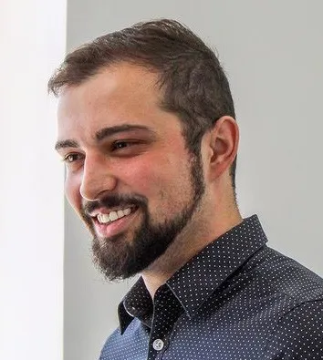 Bruno Montowski smiling, in a dark shirt